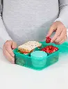 41685_1.25l_lunch_bentocube_lifestyle_bench_food_hands_open_teal.webp